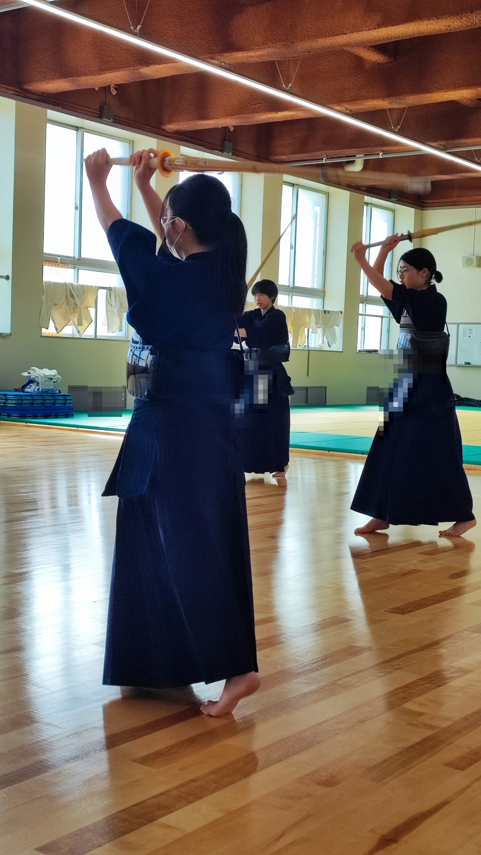 Kendo practitioners training in a wooden dojo